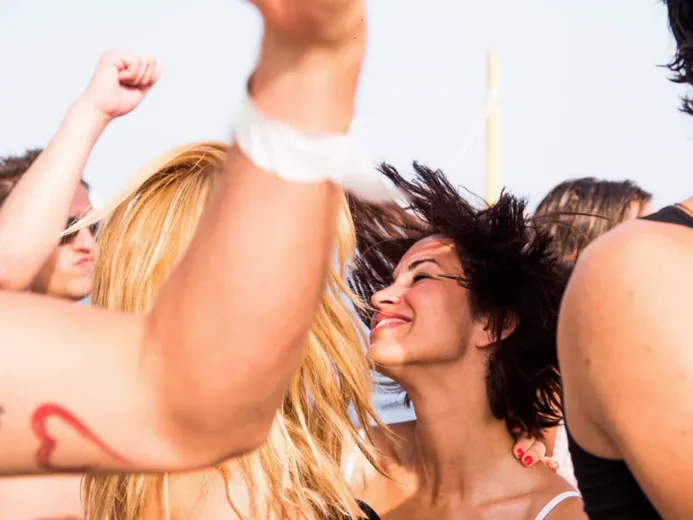 Guests dancing at sunset on the boat